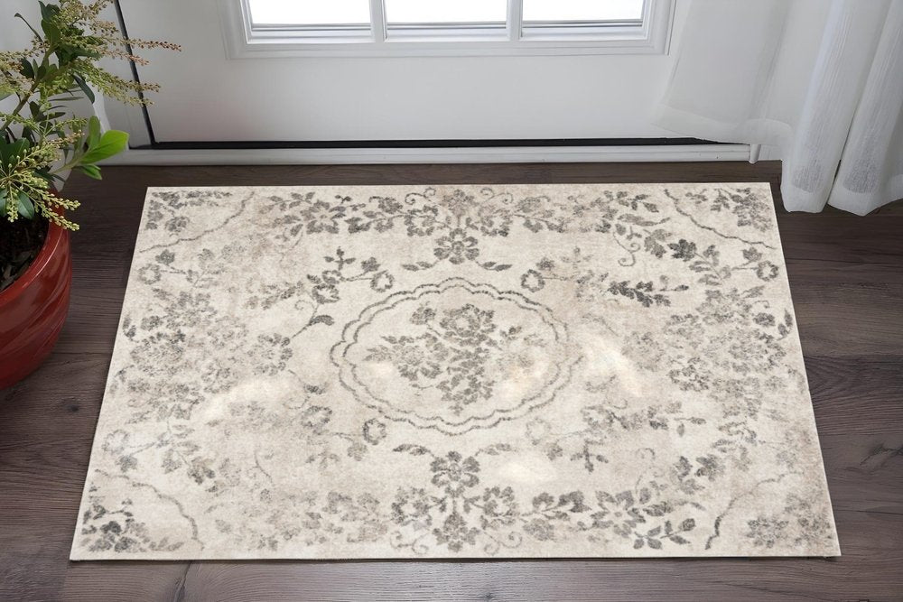 5' X 8' Gray And Tan Floral Distressed Area Rug