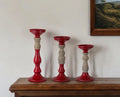 Set of Three Red And Natural Ornate Resin Tabletop Pillar Candle Holders
